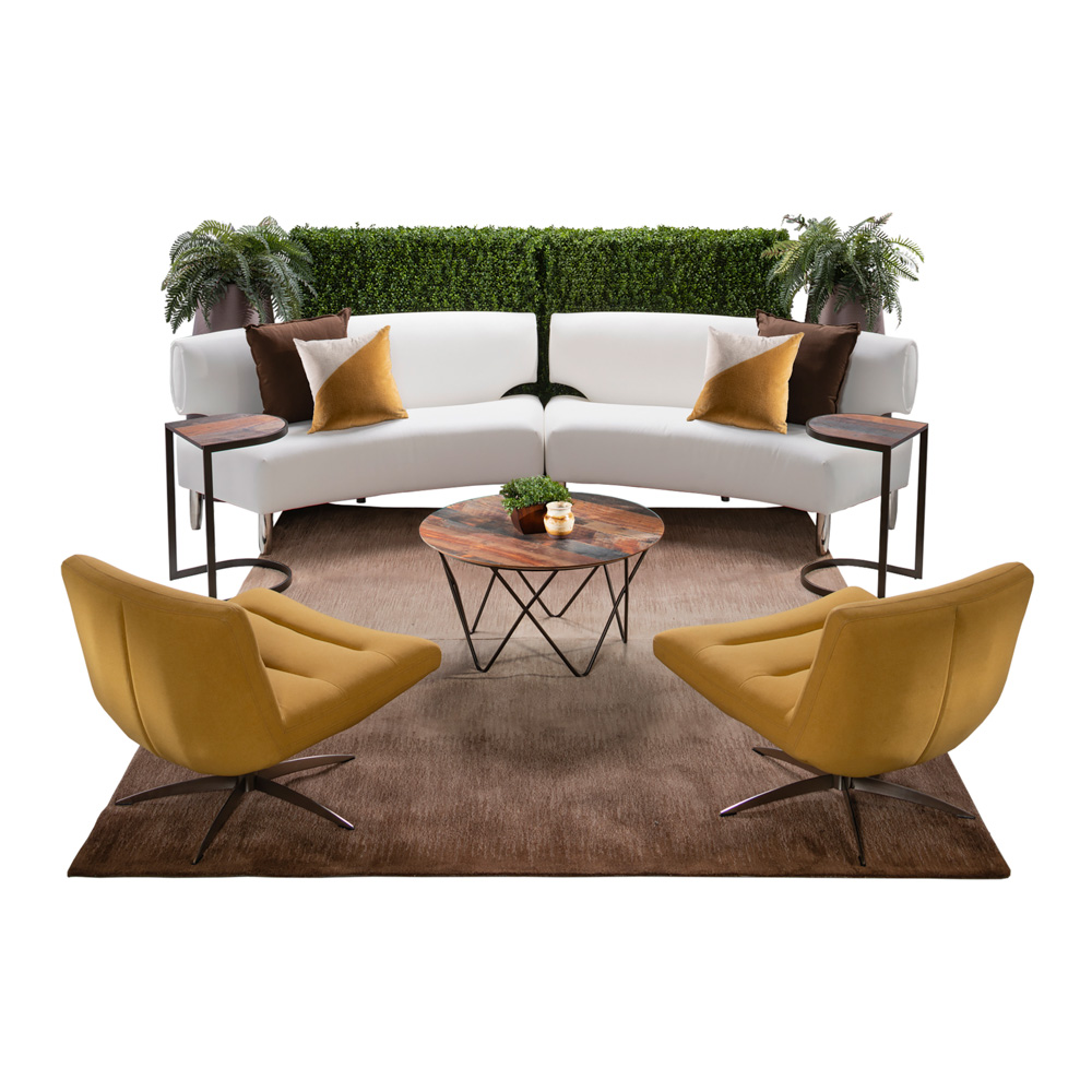 green soft seating set up with life like trees and orange accents