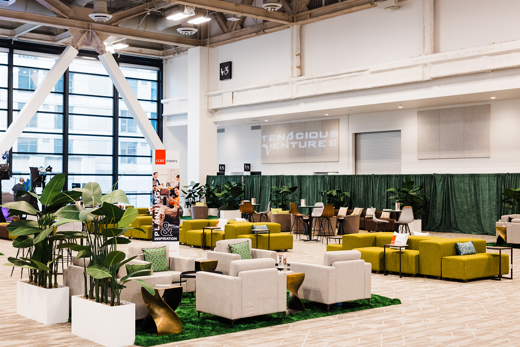 outdoor event with gray soft seating and red and green accents